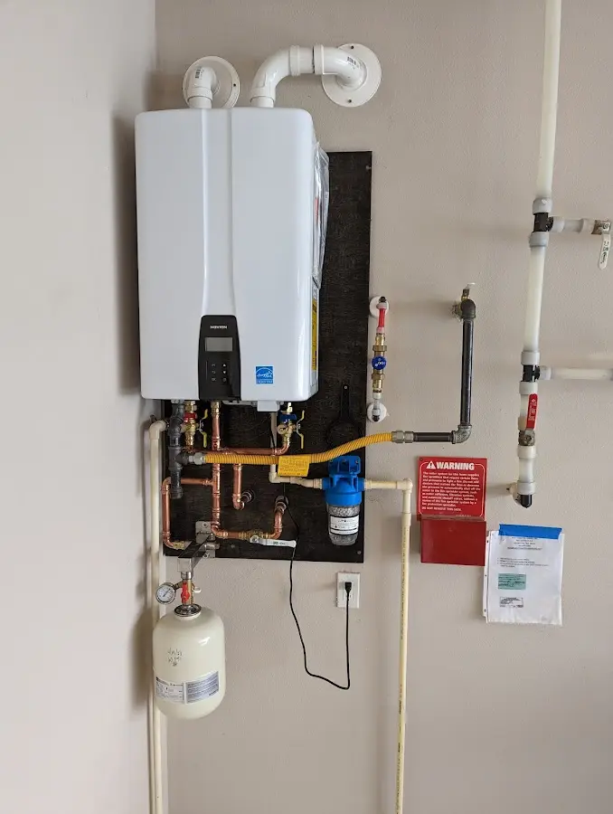 Professional plumber installing copper piping in a Ravenna home